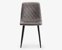 Stol med polstret sæde og ryglæn betrukket med blødt, gråt velourstof. Ryglænet og sædet har et quiltet design med diamantmønster, som giver ekstra struktur og stil. Stolen står på fire slanke, sorte metalben, der smalner let ind mod gulvet og giver et moderne og elegant udtryk.