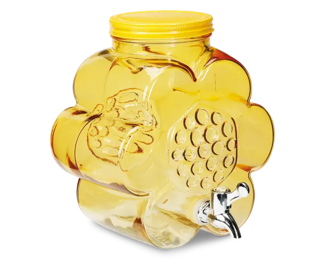 En gennemsigtig gul glasbeholder formet som en blomst, med et bikubemønster på fronten. Den har et gult skruelåg og en sølvfarvet metalhane nederst for nem udskænkning.