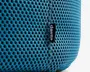 Nærbillede af en blå pude med åndbart meshstof, der har jævnt fordelte huller for ventilation. Syningen ses tydeligt langs midten, og der er et lille sort stofmærke med mærket 'daells' syet ind i sømmen.