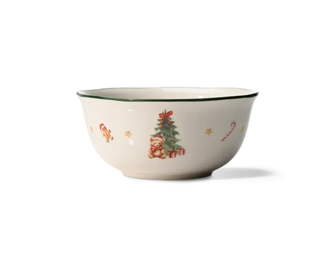 Hvid keramisk skål med mørkegrøn kant og små julemotiver, herunder en bamse ved et pyntet træ, en honningkagefigur, en candy cane og små stjerner.