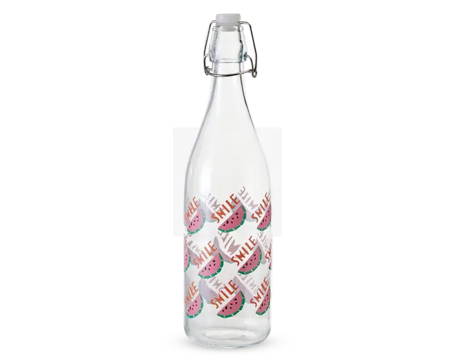 Klar glasflaske med metal-låg, der kan klikkes fast. Flasken er dekoreret med et gentagende mønster af vandmelonskiver og ordet 'SMILE' skrevet med røde bogstaver. Designet er legende og farverigt med grønne, lyserøde og røde detaljer.