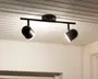 Loftmonteret lampearmatur med et moderne, minimalistisk design. Den har en sort metalstang med to justerbare cylindriske spotlys, som giver mulighed for retningsbestemt belysning. Armaturet er fastgjort til loftet med en rund base, og spotlysene har en mat sort finish med hvide indersider for bedre lysrefleksion.