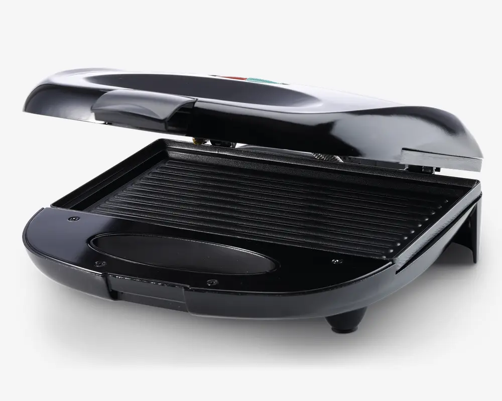 Kompakt elektrisk grill med elegant sort finish, hængslet låg og non-stick rillet stegeflade til grillning. Grillen har et skråt design, der leder fedt væk, samt en aftagelig drypbakke for nem rengøring. Håndtaget er bredt og ergonomisk for sikker åbning og lukning.
