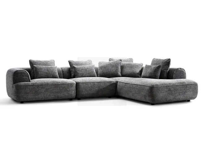 Stor grå hjørnesofa med lav profil, afrundede armlæn og flere løse ryghynder; chaiselong på højre side.