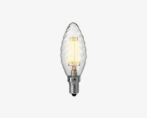 Klar glaspære med snoet, flammeformet design og synlige LED-filamenter indeni. Soklen er af metal med skruefatning, der passer til E14 sokler. Glasoverfladen har en dekorativ, spiralformet struktur, som giver et elegant udtryk og gør den velegnet til lamper, hvor pæren er synlig.