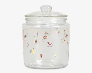 Klar glasbeholder med rundt låg og knop som håndtag. Beholderen er dekoreret med små, farverige illustrationer med juletema, såsom slikstokke, hjerter, kristtorn, gyngehest, pretzel, engel og andre festlige motiver, der hænger fra tynde gyldne linjer rundt om den øverste del af glasset.