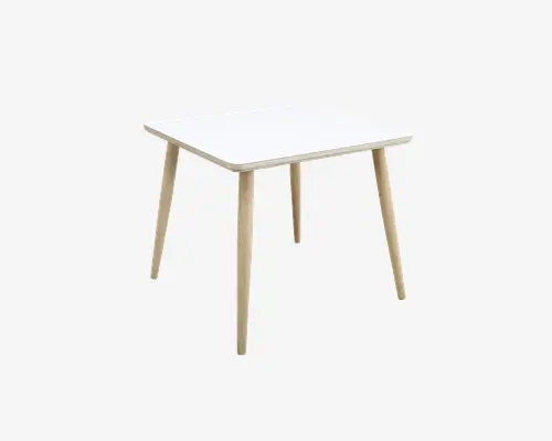 Firkantet bord med en glat, hvid bordplade og afrundede kanter, understøttet af fire skråtstillede ben i lyst træ. Designet er minimalistisk og moderne, velegnet til spise- eller arbejdsbrug.