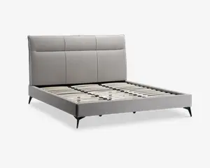 Moderne sengeramme med et lysegråt polstret hovedgærde, der har tre store rektangulære paneler. Rammen har en lav profil med matchende gråt stof på sider og fodende. Sengen har jævnt fordelte lameller i træ til madrasstøtte og står på slanke, skrå sorte ben.