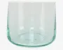 Klar, cylindrisk glasbeholder med et let grønligt skær, glat overflade og en tyk, afrundet bund. Glasset ser ud til at være mundblæst med diskrete variationer og en synlig samling nær bunden.