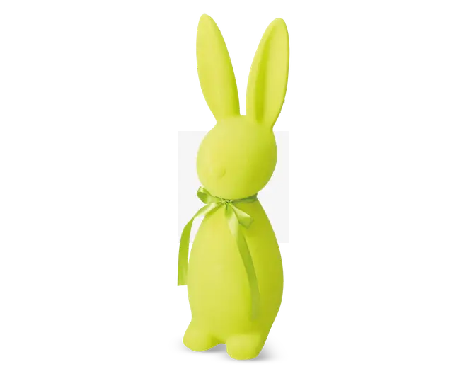 En lys gulgrøn kaninfigur med en glat, mat overflade. Kaninen har lange opretstående ører og en rund krop med minimale ansigtstræk. Den er pyntet med et lysegrønt satinbånd, der er bundet i en sløjfe omkring halsen.