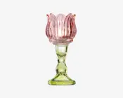 Dekorativ glasholder med en lyserød, blomsterformet top, der ligner kronblade, samt en solid, gennemsigtig grøn fod og stilk. Designet har bløde, afrundede former og en blank overflade, hvilket giver et elegant og kunstnerisk udtryk. Velegnet til at holde stearinlys eller små dekorative genstande.