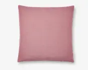 Firkantet pude med et blødt, støvet rosa betræk. Stoffet har en let vævet struktur, der giver en mat overflade. Kanterne er pænt syet, og der er et lille stofmærke i den ene side. Puden ser fyldig og komfortabel ud, velegnet til brug på sofa eller seng.