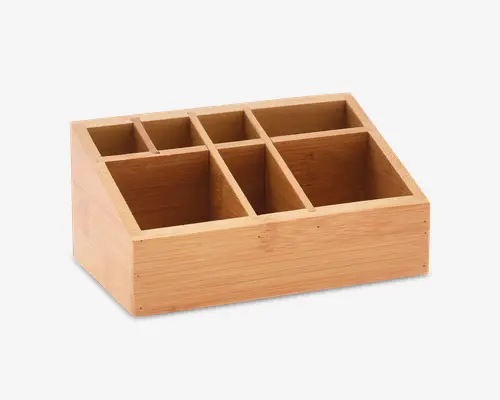 Rektangulær træorganizer med seks rum i forskellige størrelser. Organizeren er lavet af lyst træ, sandsynligvis bambus, og har glatte kanter samt en naturlig finish. Rummene er arrangeret i to rækker, med tre mindre sektioner bagerst og tre større sektioner forrest, hvilket gør den velegnet til sortering og opbevaring af forskellige genstande.