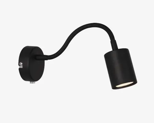 Væghængt armatur i mat sort med cylinderformet lampehoved og fleksibel, justerbar svanehals. Basen er rund med en synlig skrue til montering, og lampehovedet er designet til at give et fokuseret lys. Moderne, minimalistisk design, velegnet til arbejds- eller læsebelysning.