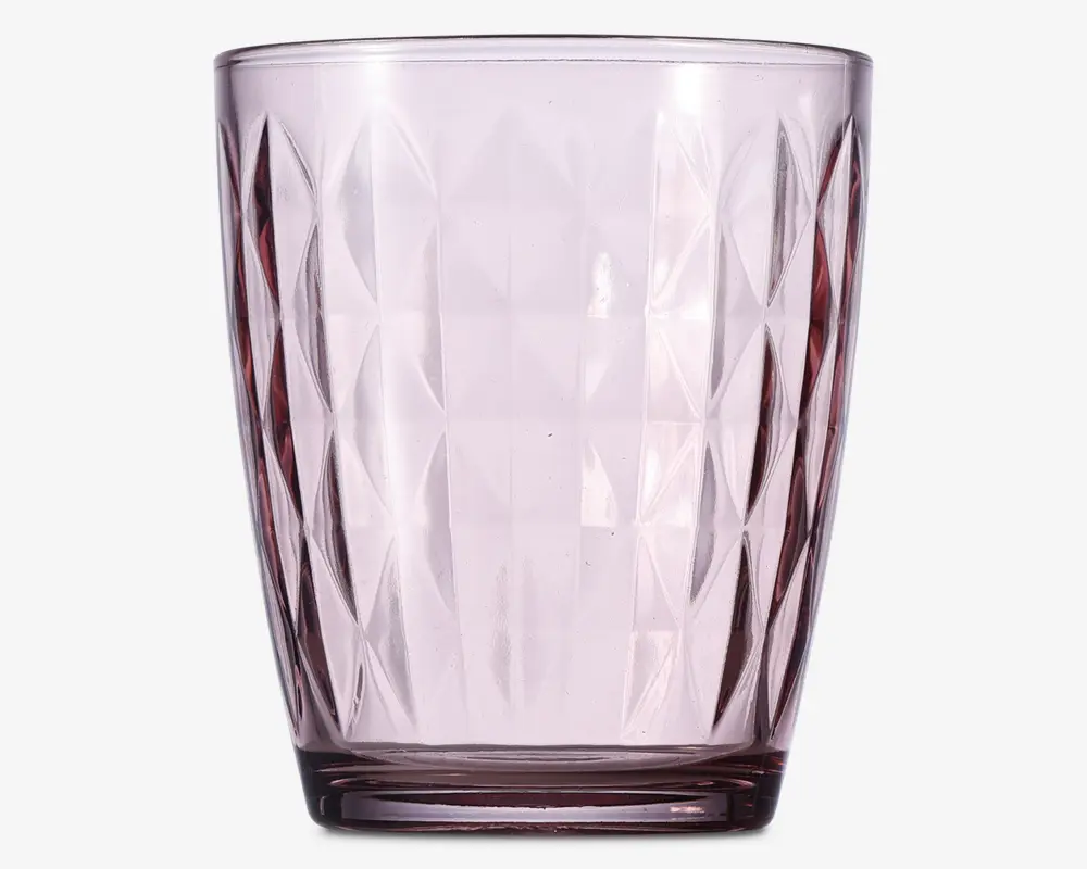 Transparent lyserød drikkeglas med facetslebet diamantmønster på overfladen. Glasset har en let konisk form, bredere foroven og smallere ved bunden, samt en tyk bund for ekstra stabilitet.