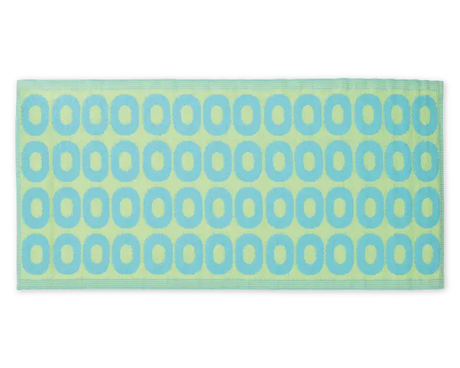 Rektangulært produkt med en blød, tekstureret overflade, der har et gentagende mønster af blå ovale ringe på en lysegrøn baggrund. Kanterne er pænt syet, og det samlede design er moderne og legende.