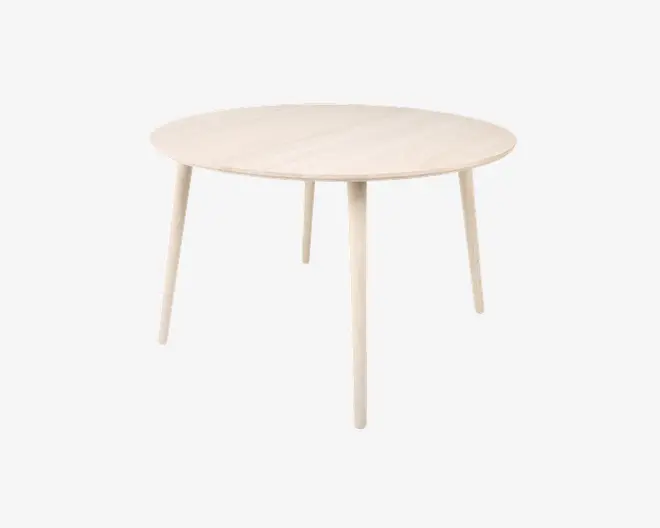 Et rundt bord med lys træfinish, der har en glat, flad bordplade og fire slanke, koniske ben. Designet er minimalistisk og moderne med rene linjer og synlig træstruktur på bordpladen.