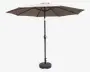 Stor udendørs parasol med rund, taupefarvet dug og solid sort metalstang. Har et håndsving til nem åbning og lukning. Parasollen står på en tung, rund fod for stabilitet. Dugen understøttes af flere stivere, som giver god styrke og jævn spænding.