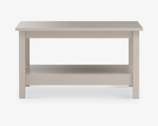 Rektangulært bord med en glat, flad bordplade og en åben hylde nederst til ekstra opbevaring. Bordet har lige, solide ben og et minimalistisk design med rene linjer. Overfladen har en lys, neutral farve, som giver et moderne og alsidigt udtryk.