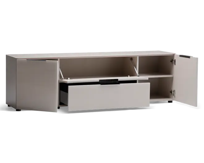 Rektangulær opbevaringsenhed i lys beige farve med et moderne, minimalistisk design. Har to sidekabinetter med hængslede låger, hver med en hylde til organisering. Midtersektionen har et vandret rum med en opadgående låge, der understøttes af metalarme, og nedenunder er der en bred udtræksskuffe med sort greb. Enheden står på korte, skjulte ben, hvilket giver et stilrent, svævende udtryk.