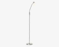 Høj, slank gulvlampe med børstet metalfinish, rund og stabil fod samt et justerbart arm, der bøjer på to steder. Lampens hoved er lille og kuppelformet med en mat glas-skærm, der giver blødt og diffust lys.