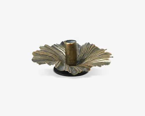 Dekorativ holder fremstillet af metal med antik messingfinish. Basen er formet som et stiliseret, tekstureret blad med detaljerede årer og bølgede kanter, der stråler ud fra midten. Den centrale cylindriske del er designet til at holde et lys sikkert. Udtrykket er elegant og vintage-inspireret, velegnet til at tilføje et sofistikeret præg til boligindretningen.
