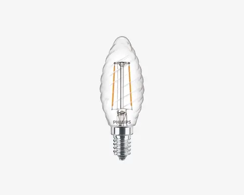 Klar glaspære med snoet, flammeformet design. Pæren har synlige LED-filamenter, der er placeret lodret indeni og giver et vintage udseende. Den har en blank, metallisk skruesokkel for nem montering. Det samlede udtryk er dekorativt og egner sig til lamper, hvor pæren er synlig.