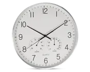 Rund vægur med hvid urskive og sorte tal, udstyret med tre sorte visere til timer, minutter og sekunder. Uret har også to små målere nederst: én til temperatur (termometer) og én til luftfugtighed (hygrometer), begge med tydelige markeringer og sorte visere. Rammen er sølvfarvet, og designet er minimalistisk og let at aflæse.