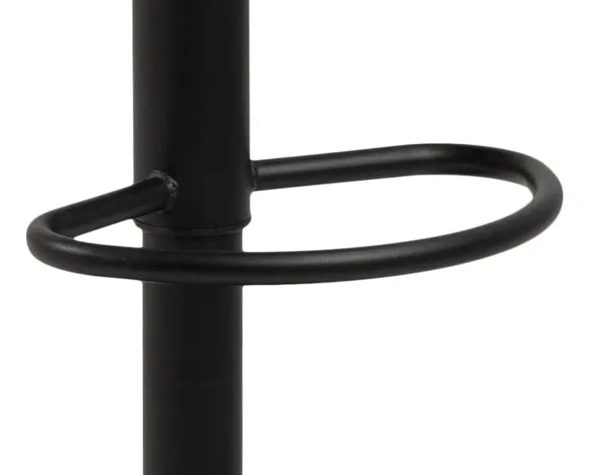 Nærbillede af en sort metal fodstøtte i cirkelform, der er fastgjort til en lodret stang, med en glat, mat overflade og solide svejsede samlinger.