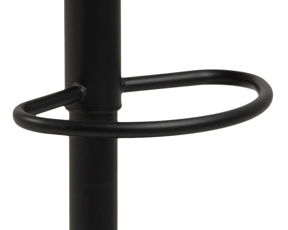 Nærbillede af en sort metal fodstøtte i cirkelform, der er fastgjort til en lodret stang, med en glat, mat overflade og solide svejsede samlinger.