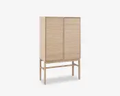 Høj skab lavet af lyst træ med to låger, der har vandrette lameldetaljer. Skabet står på fire slanke ben, som er forbundet med støttebøjler, hvilket giver et løftet og let udtryk. Designet er minimalistisk og moderne med rene linjer og en naturlig træfinish.