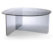 Moderne sofabord med et klart glasdesign og en unik geometrisk form. Bordpladen er rundet med glatte kanter, og basen består af to krydsende glasplader, som giver stabilitet og et visuelt markant udtryk. Det gennemsigtige materiale giver bordet et minimalistisk og elegant look, der passer til moderne indretning.