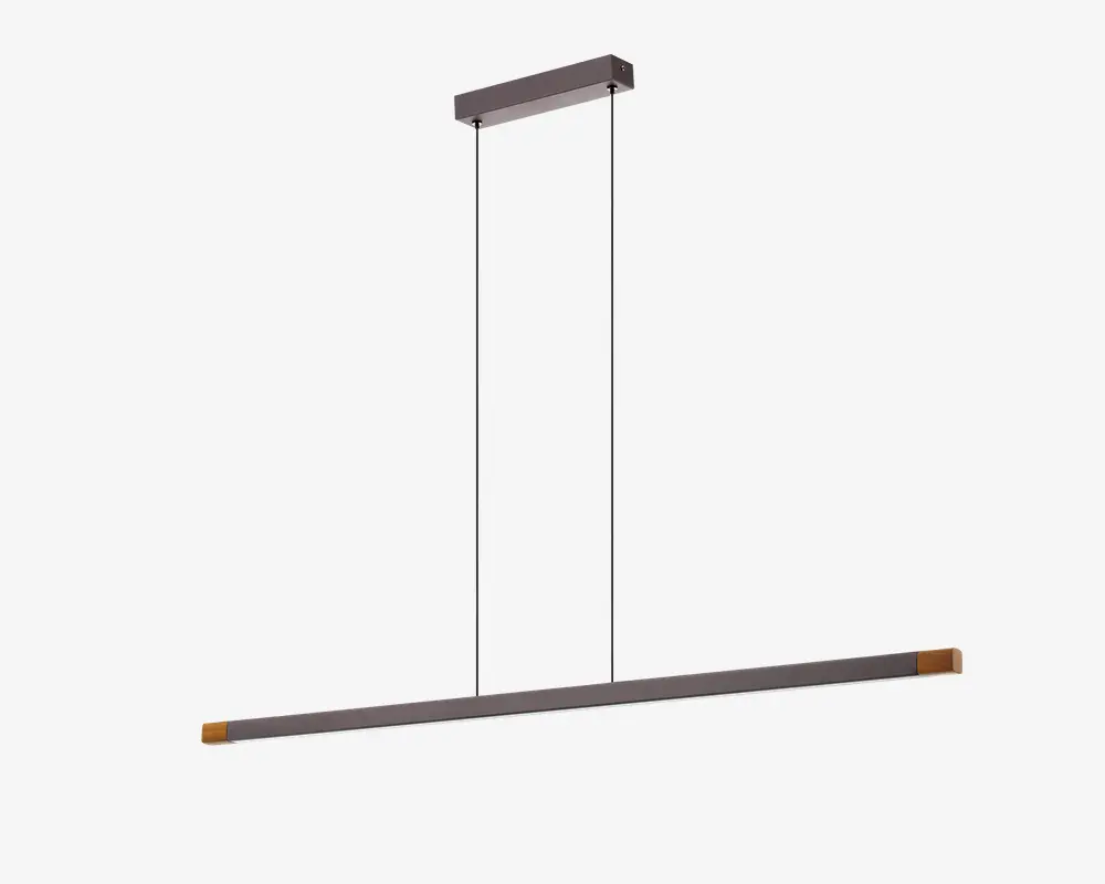 Et moderne, minimalistisk pendellampe-armatur med en lang, slank vandret stang, der hænger fra loftet i to tynde sorte kabler. Stangen har en mat metallisk finish med diskrete guldfarvede detaljer i enderne, hvilket giver et stilrent og nutidigt udtryk. Lampen er designet til at give jævn belysning og er ideel til placering over spiseborde eller køkkenøer.