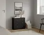 En kompakt kommode med tre skuffer i mat sort finish og enkle, runde sølvfarvede greb. Skufferne er jævnt fordelt og har et rent, moderne design. Ovenpå står en hvid vase med tørret pampasgræs, en stak bøger og en lille dekorationsgenstand. Kommoden står på et lyst trægulv op ad en lysegrå væg og er stylet med neutral, minimalistisk indretning.