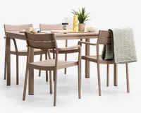 Et moderne spisesæt bestående af et rektangulært bord og seks matchende stole i en afdæmpet beige farve. Stolene har et enkelt design med lamel-ryg, og to af stolene har armlæn. Bordet er dækket med morgenmadsting, herunder en kop, skål, tallerkener, en karaffel, et glas og en dekorativ plante. Et gråt, tekstureret tæppe er lagt over ryggen på en af stolene, hvilket giver et hyggeligt præg.