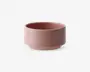 En rund skål med mat finish i en afdæmpet rosa farve. Skålen har lige sider og en flad bund med en let kant, hvilket giver den et moderne og minimalistisk udtryk. Overfladen er glat og uden dekoration, hvilket fremhæver det enkle design.