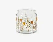 Klar glasbeholder med bred åbning og let rundet krop, dekoreret med et mønster af orange, gule og brune vilde blomster samt grønt løv. Blomstermotivet er trykt rundt om ydersiden og giver beholderen et botanisk og rustikt udseende.