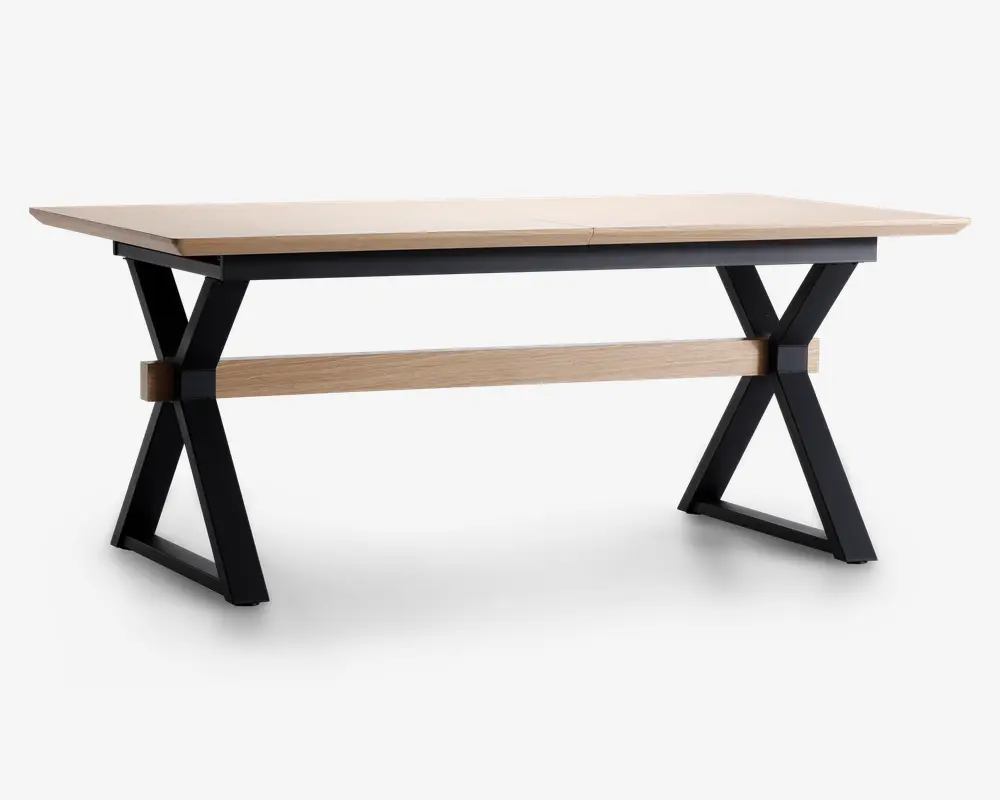 Rektangulært bord med en lys træbordplade og sorte metalben i X-form. Bordet har en tværgående støttebjælke i matchende lyst træ mellem benene for ekstra stabilitet. Designet kombinerer moderne og industrielle elementer med rene linjer og solid konstruktion.
