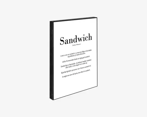 Minimalistisk vægkunst med sort ramme, hvor ordet 'Sandwich' står øverst med store, fede bogstaver, efterfulgt af en humoristisk eller tankevækkende definition og flere linjer tekst i en enkel, moderne skrifttype. Baggrunden er hvid, og det samlede design er simpelt og elegant, velegnet til moderne boligindretning.