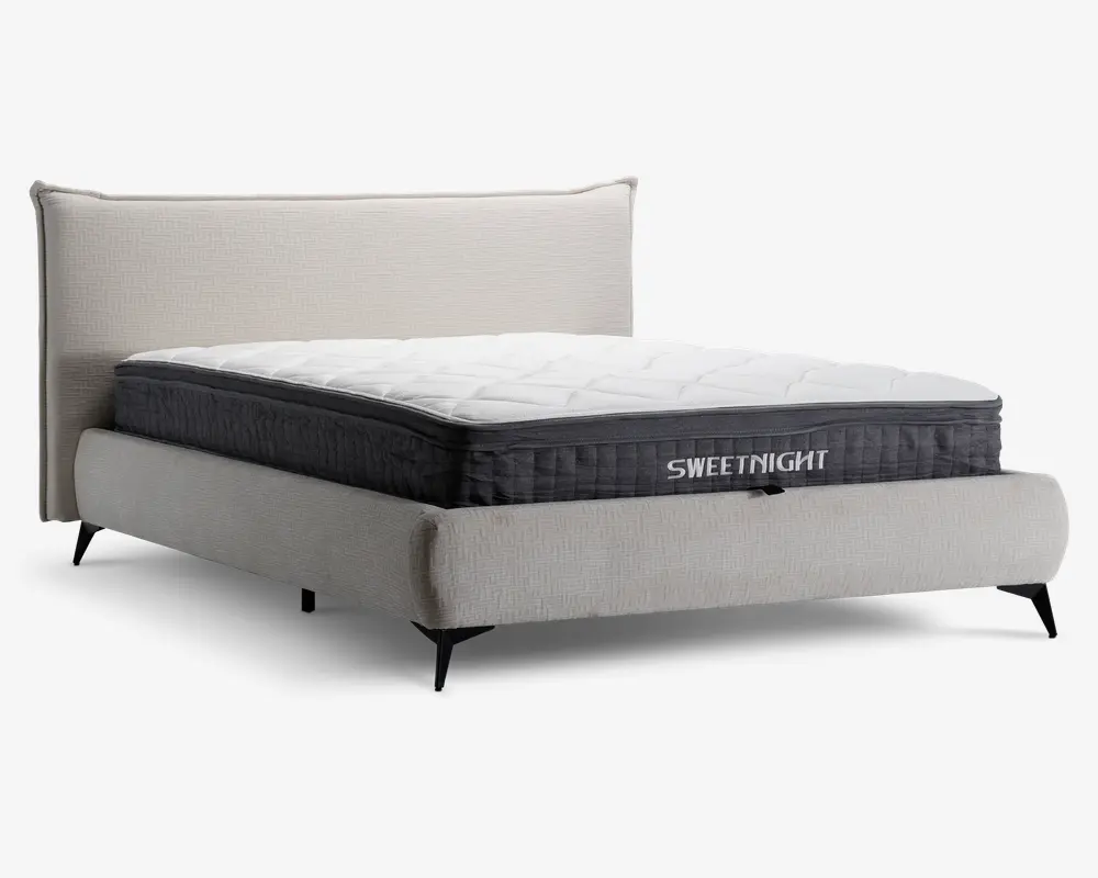 En moderne seng med en lysebeige polstret ramme og hovedgærde, udstyret med en tyk, quiltet madras med hvid top og mørkegrå sider. Madrassen har et synligt mærkenavn 'SWEETNIGHT' på siden og en blød, ekstra polstret overflade for øget komfort. Sengen står på slanke, sorte ben, hvilket giver et moderne udtryk.