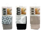 Tre indpakkede badesæt, hver med et badeforhæng, bademåtte og gardinringe. Det første sæt har et geometrisk diamantmønster i grå nuancer med en matchende lysegrå tekstureret måtte. Det andet sæt har et moderne sort-hvidt stribet forhæng med en ensfarvet sort tekstureret måtte. Det tredje sæt viser et taupefarvet forhæng med diskrete vanddråbe-designs og en beige tekstureret måtte. Hvert sæt indeholder tre gardinringe i matchende farver.