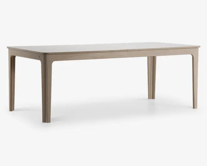 Rektangulært bord med en glat, lys bordplade og matchende ben. Bordet har et minimalistisk design med let afrundede hjørner og kanter, og benene er lige med diskrete indadgående kurver øverst. Overfladen har en mat finish, hvilket giver et moderne og rent udtryk.