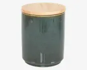 Cylindrisk beholder med en glat, blank mørkegrøn keramisk krop og et fladt, rundt låg af lyst træ. Låget passer tæt på toppen, og keramikken har diskrete farvevariationer og en let plettet overflade.