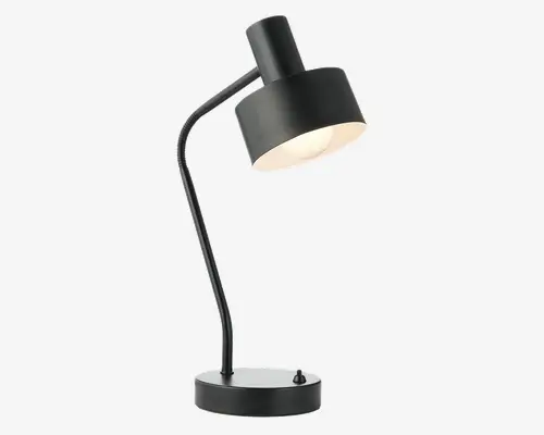 Skrivebordslampe i mat sort med cylindrisk lampeskærm og en let vinklet, slank arm. Lampen har en rund, solid fod med en lille tænd/sluk-knap. Lampeskærmen kan justeres, så lyset kan rettes, og designet er moderne og minimalistisk.