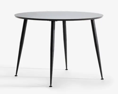 Rundt bord med en glat, flad overflade og fire slanke, tilspidsede metalben. Bordpladen har et minimalistisk design med en tynd profil, og benene er vinklet udad for stabilitet. Finishen er mat, hvilket giver bordet et moderne og stilrent udseende.