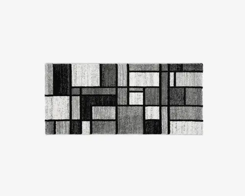 Rektangulært tæppe med et moderne geometrisk mønster bestående af forskellige størrelser rektangler og firkanter i nuancer af sort, grå og hvid. Designet er abstrakt og symmetrisk, hvilket giver et moderne udtryk, der passer til nutidige indretninger. Overfladen ser blød og tekstureret ud.