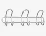 Væghængt stativ i sølvfarvet metal med tre store, buede kroge og seks mindre kroge nedenunder, alle fastgjort til to vandrette stænger. Designet er minimalistisk og moderne med afrundede kanter og en glat overflade. Stativet er fastgjort til væggen med synlige skruer i hver ende.
