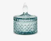 Rund glasbeholder med diamantmønsteret tekstur, udstyret med et matchende låg med dekorativt spids håndtag. Beholderen er transparent med et let blåligt skær, og låget passer tæt, hvilket gør den velegnet til opbevaring af små genstande. Det detaljerede design giver et elegant, vintage udtryk.