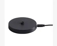 En rund, flad, sort base med mat overflade og et lille gevindhul i midten, sandsynligvis til montering af en anden komponent. Basen har et USB-kabel tilsluttet på siden, hvilket indikerer, at den får strøm eller oplades via USB. Designet er minimalistisk og moderne.