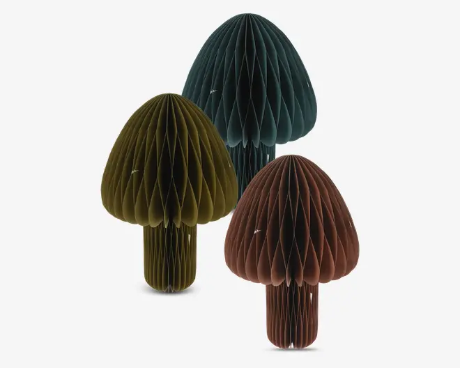 Sæt med tre dekorative papirornamenter formet som svampe, hver med en bikagestruktur. Ornamenterne findes i tre forskellige farver: mørkegrøn, olivengrøn og dyb brun. Hver svamp har en rund hat og en cylindrisk stilk, hvor bikagestrukturen giver et tredimensionelt, tekstureret udseende. Ornamenterne er designet til at stå oprejst og tilføjer et legende, naturligt præg til boligindretningen.